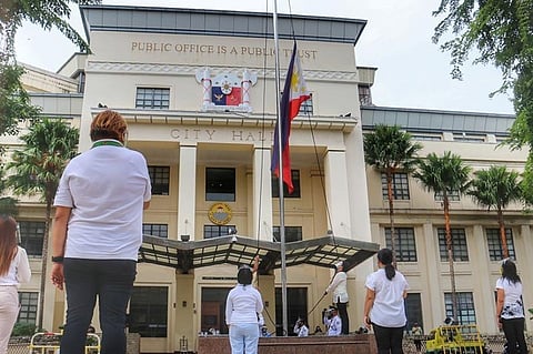 HONORING HEROES. A simple flag raising ceremony is held on National Heroes' Day, Aug. 31, 2020, outside Cebu City Hall. In attendance are representatives of Mayor Edgardo Labella and Vice Mayor Michael Rama and City Hall employees. Labella was at the Cebu City Sports Center for the send-off of police officers from Eastern and Western Visayas. (Amper Campaña)