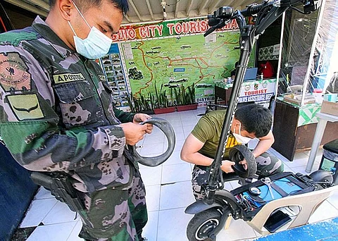 MAINTENANCE. Tourist police officers troubleshoot their e-scooter in preparation for the tourism opening and easing of travel restriction of domestic tourist in Baguio City coming from Ilocos. These e-scooters are used to patrol and secure major parks in the city like Burnham Park. (Jean Nicole Cortes)