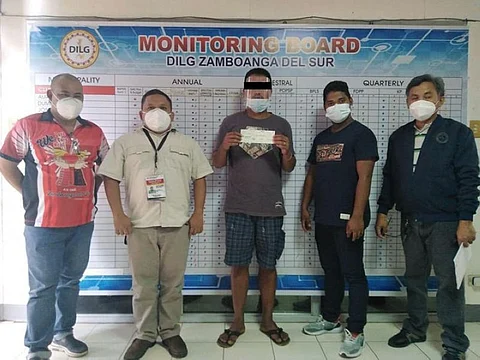 ZAMBOANGA. The government, through the Enhanced Comprehensive Local Integration Program, continues to give livelihood assistance to former members of the New People's Army (NPA) who surrendered to live a new life. A photo handout shows another former NPA member (center) receives assistance from the government, through the Department of the Interior and Local Government. (SunStar Zamboanga)
