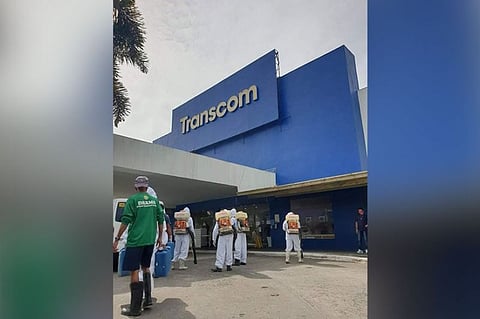 BACOLOD. Personnel of the City Disaster Risk Reduction and Management Office conduct disinfection and decontamination at the premises of business process outsourcing firm, Transcom Bacolod, in Barangay Tangub on Monday, February 1, 2021, following reports that 41 of its employees tested positive for coronavirus. (Photo by Adrian Prietos)