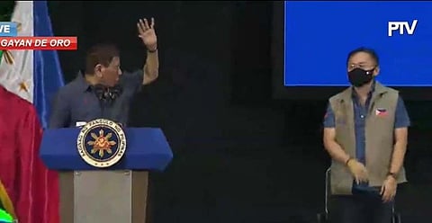 President Duterte instructs Senator Bong Go to waive his hand higher during a gathering in Cagayan de Oro on Friday, March 6, 2021. (Screengrab from PTV)