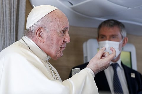 Pope Francis speaks to journalists, Monday, March 8, 2021, while flying back to The Vatican at the end of his four-day trip to Iraq where he met with different Christian communities and Shiite revered cleric Grand Ayatollah Ali al-Sistani. At right pope's spokesperson Matteo Bruni. (AP Photo)