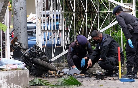 INDONESIA. Members of a police bomb squad inspect the wreckage of a motorbike used to carry out Sunday's (March 28, 2021) suicide bomb attack at the Sacred Heart of Jesus Cathedral in Makassar, South Sulawesi, Indonesia, Monday, March 29, 2021. (AP)