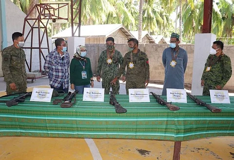 ZAMBOANGA. The municipal officials of Tabuan Lasa, Basilan headed by Mayor Brenda Junaid (3rd, left) signed an agreement Wednesday, May 26, to support the implementation of the small arms and light weapons that seeks to eradicate the proliferation of loose firearms. A photo handout shows Junaid and top military and police officials in a casual conversation after the signing of the agreement in Lanawan village, Tabuan Lasa. (SunStar Zamboanga)