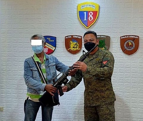 SURRENDER. Two Abu Sayyaf bandits, who are involved in high-profile atrocities, surrender Wednesday, September 8, to government authorities in Basilan province as they are exhausted from fleeing due to continuous military offensive against them. A photo handout shows one of the surrenderers hands over his rifle to a military official when they surrendered. (SunStar Zamboanga)