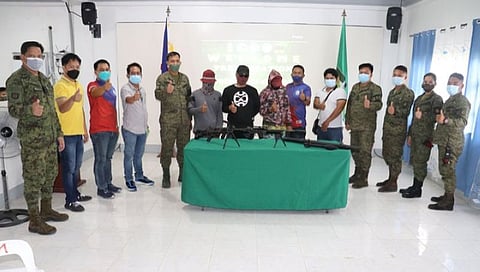 BIFF SURRENDERERS. Three members of the Bangsamoro Islamic Freedom Fighters surrender hand over their firearms to the troops of the 92nd Infantry Battalion on Tuesday, September 14, in Maguindanao. A photo handout shows the three surrenderers (faces covered with masks and wearing baseball caps) together with military and municipal government officials making a thumbs-up sign during a souvenir photo at the Old Capitol in Satan village, Shariff Aguak, Maguindanao. (SunStar Zamboanga)