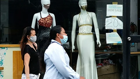 MANILA. In this file photo. women walk past mannequins wearing face masks advertised for sale at a shop in Makati City.