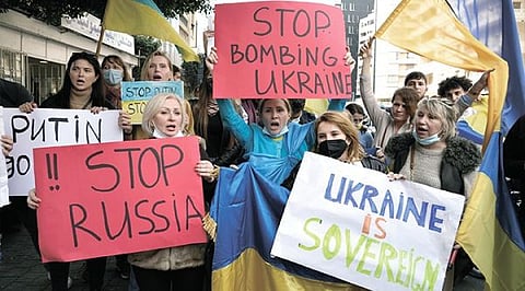 PROTEST. Ukrainians who live in Lebanon hold placards and chant slogans during a protest against Moscow's wide-ranging attack on their country, outside the Russian embassy in Beirut, Lebanon, Thursday, Feb. 24, 2022. / AP