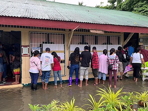 WON'T STOP VOTING. The flooding at San Vicente Elementary School, Barangay San Vicente, Panabo City, Davao del Norte did not stop voters from casting their votes on May 9, 2022. (Krizzy Daugdaug)