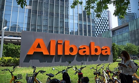 FILE - The logo of Chinese technology firm Alibaba is seen at its office in Beijing, Tuesday, Aug. 10, 2021. Alibaba is separating the company into six business groups as it looks to react faster to market changes and increase their value. Alibaba Group Holding Ltd. said, Tuesday, March 28, 2023, in a regulatory filing that it will be split into the Cloud Intelligence Group, Taobao Tmall Business Group, Local Services Group, Global Digital Business Group, Cainiao Smart Logistics and Digital Media and Entertainment Group. (AP Photo)