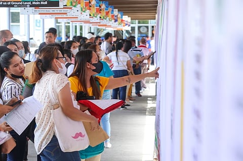JOBSEEKER. A woman looks at the bulletin board posted outside SM City Davao to see the available jobs she can apply for. Spearheaded by the Department of Labor and Employment, the 2023 Labor Day Job Fair featured about 3,000 job vacancies from 46 local companies participating. Over 100 individuals were hired on the spot.