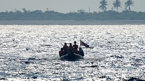 MANILA. Philippine Coast Guard personnel from BRP Malabrigo transports supplies to the Philippine-claimed West York Island, locally known as Likas island at the South China Sea on Thursday April 20, 2023. (AP)