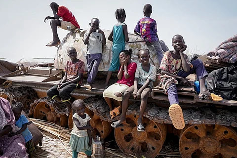 Children sit and play on the remains of a tank, at the river port in Renk, South Sudan Wednesday, May 17, 2023. Tens of thousands of South Sudanese are flocking home from neighboring Sudan, which erupted in violence last month. (AP Photo)