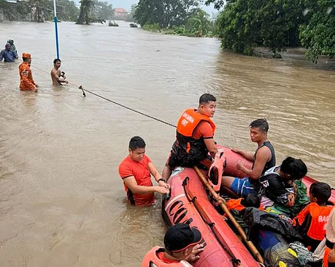 ILOCOS. In this photo provided by the Philippine Coast Guard, rescuers use a rubber boat along floodwaters caused by Typhoon Egay as they evacuate residents to higher grounds in Bacarra, Ilocos Norte province, northern Philippines on Wednesday July 26, 2023. (AP)