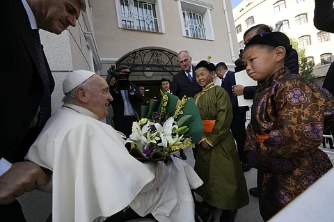 Children in traditional dress welcome Pope Francis arriving for a meeting with charity workers and for the inauguration of the House of Mercy in Ulaanbaatar, Monday, Sept. 4, 2023. Francis toured the House of Mercy in the final event of an historic four-day visit to a region where the Holy See has long sought to make inroads. (AP)