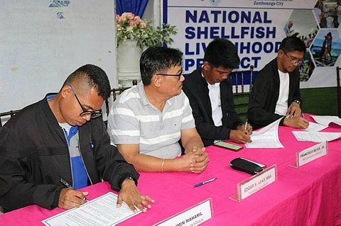 ZAMBOANGA. The Bureau of Fisheries and Aquatic Resources and the National Fisheries Development Center enter into a memorandum of agreement for the implementation of National Shellfish Livelihood Project to provide alternative livelihood to small-scale fishermen during the sardine close fishing season, scheduled to commence on November 15, 2023. A photo handout shows BFAR Regional Director Al-Zath Kunting (right) and officials of the NFDC penned the MOA last week for the implementation of the NSLP in Zamboanga Sibugay. (SunStar Zamboanga)
