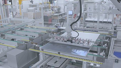 Mondragon’s layup systems use a 6-axis robotic vacuum arm to position cell strings on the module stack before further assembly steps. (Photo Credit: Mondragon Assembly)