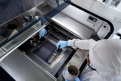 Fraunhofer ISE researchers with partners have improved the traditional screen printing process for fine line metallization to save on 30% silver during cell production. Pictured is the metallization paste being applied on a screen printing machine. (Photo Credit: Fraunhofer ISE/Dirk Mahler)
