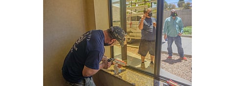 Pictured is the UbiQD solar window being installed at the Holiday inn Express and Suites in Los Alamos, New Mexico. (Photo Credit: UBiQD, Inc.)