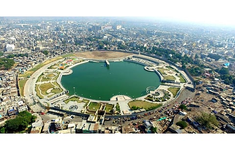 GUVNL’s 750 MW+750 MW solar tender will be conducted as an e-reverse auction, a tool that’s responsible for historically low bidding for solar in India. MNRE is now getting ready to end the same. Pictured is an aerial view of Gopi Talav in Surat district of Gujarat. (Photo Credit: District Administration Surat)
