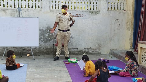 Than Singh provides books, copies, pencils and food to these children