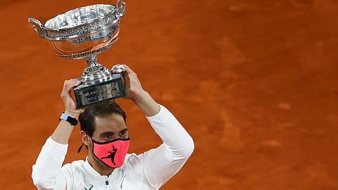 Rafael Nadal poses with the Mousquetaires Cup