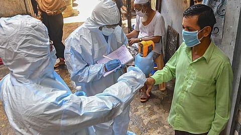 Health workers measuring temperature for coronavirus infection