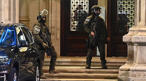 Armed policemen stand guard in front of the main entrance of the State Opera in the center of Vienna