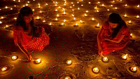 People light lamps and exchange sweets and gifts among families and friends