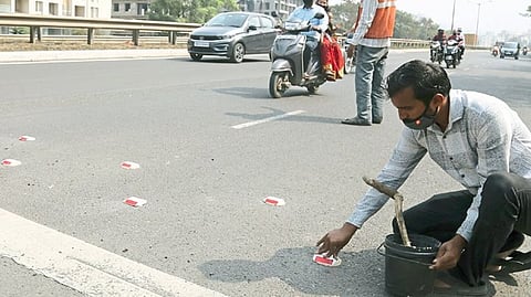 Authorities from NHAI installing stud lights at Narhe Bridge in Pune