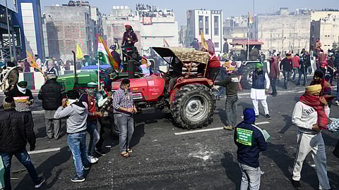 Police fire tear gas to disperse farmers during a rally as they continue to protest against the central government's recent agricultural reforms