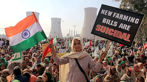 Farmers block a road during their 'chakka jam' protest as part of the ongoing agitation over new farm laws, in Bathinda.