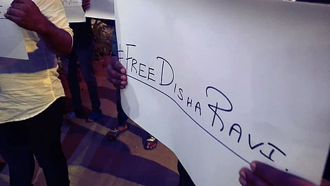 Students and supporters of activist Disha Ravi hold placards during a protest in support of activist Disha Ravi.