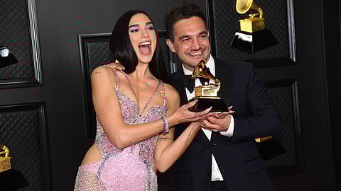In this handout photo courtesy of The Recording Academy, (L-R) Dua Lipa, winner of Best Pop Vocal Album for Future Nostalgia, and Ben Mawson pose in the media room during the 63rd Annual Grammy Awards