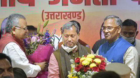 BJP leader Tirath Singh Rawat being greeted by outgoing CM Trivendra Singh Rawat after he was elected as new Chief Minister of Uttarakhand, in Dehradun, Wednesday, March 10, 2021.