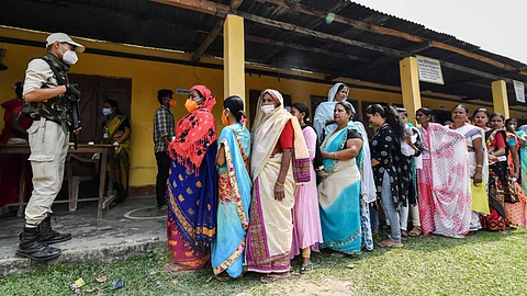 Voters wait in queue to cast their ballots during Phase 1 of Assam's legislative election in Koliabor, some 186 km from Guwahati on March 27, 2021.