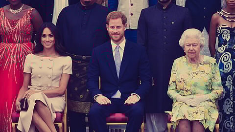 Meghan, Duchess of Sussex, Britain's Prince Harry, Duke of Sussex and Britain's Queen Elizabeth II pose for a picture during the Queen's Young Leaders Awards Ceremony at Buckingham Palace in London.