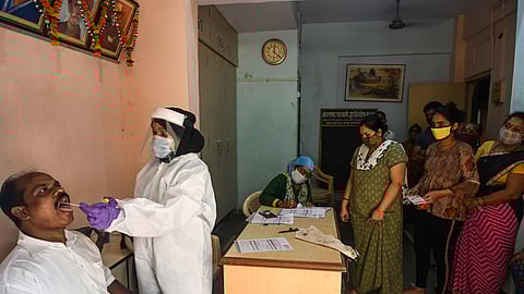 A medical staff takes a nasal swab for a Rapid Antigen Testing (RAT) test amidst rising Covid-19 coronavirus cases