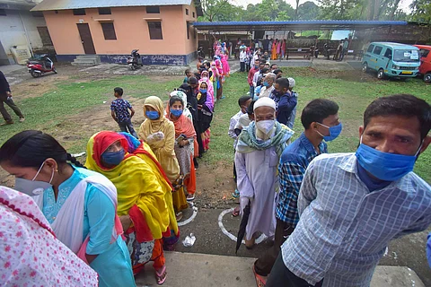 Nagaon: Voters stand in queues to cast their votes during the second phase of Assam Assembly Election 2021, in Nagaon district, Thursday, April 1, 2021.
