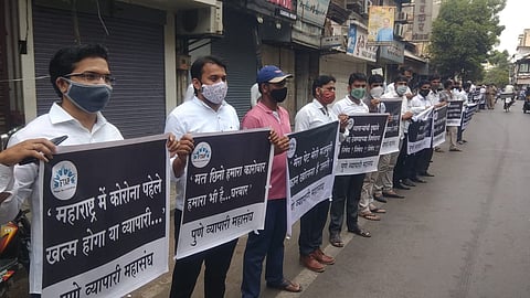 Shop owners seen protesting in Pune on Thursday.