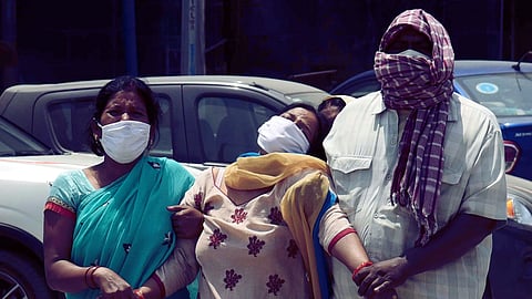 Family members mourn the death of a COVID-19 victim at Nalanda Medical College and Hospital in Patna, Bihar on Tuesday, April 27