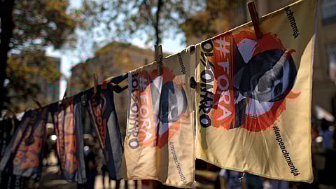 View of flags depicting Brazilian President Jair Bolsonaro as a devil are displayed for sale during a protest against his handling of the COVID-19 pandemic in Belo Horizonte, Brazil on May 29, 2021.