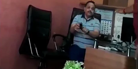 Video grab of the builder with a pistol lighter in his hand trying to intimidate the farmer