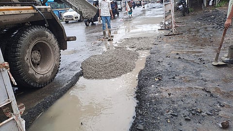 Contractor Fills Waterlogged Potholes with Cement Concrete