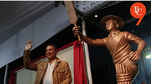 Sunil Gavaskar alongside his statue