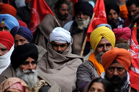 Amritsar: Farmers sit on 'dharna' outside the Deputy Commissioner's office as they protest against the Centre's new farm laws, on Dec 14, 2020. (Photo: IANS)