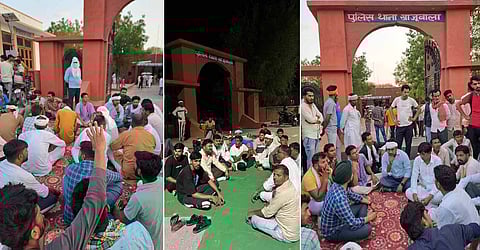 पुलिस थाने के मुख द्वार पर बैठे लोग