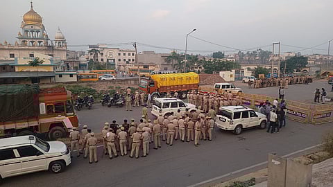 Ambala police personnel regulate traffic with barricades