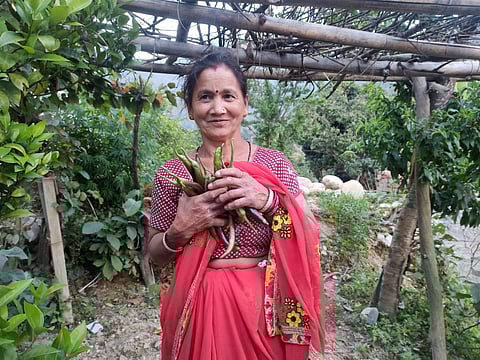 Chandra Devi, a farmer, sells her vegetable crop at Chinoni village shop
