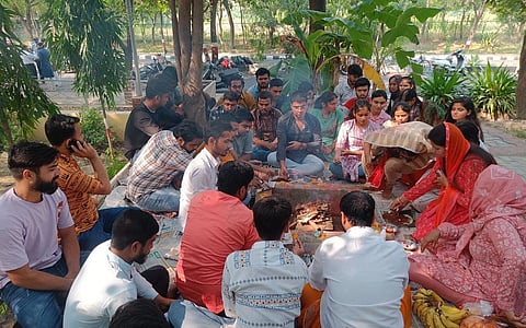 Students performing puja in the university campus.